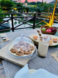 a table with cookies and a glass of milk at Shambhala in Bhopal