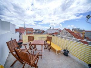 a patio with chairs and a table on a balcony at Apartments Matija in Vodice