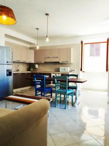 a kitchen with blue chairs and a table in it at B&B Mediterranea in Meta +24 photos
