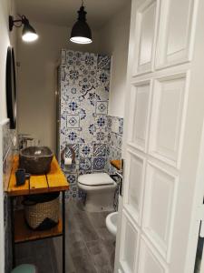 a bathroom with a toilet and a sink and a shower at B&B Mediterranea in Meta