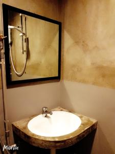 uma casa de banho com um lavatório e um espelho em Loft Pals Urbanstay Lodge, Kapit em Kapit