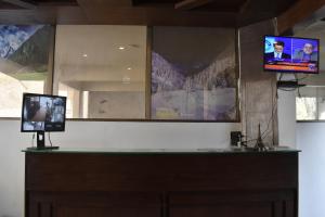 a room with two televisions on a wall at Hotel Royal Inn in Murree