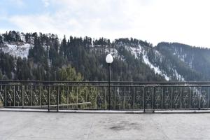 a metal fence with a view of a mountain at Hotel Royal Inn in Murree