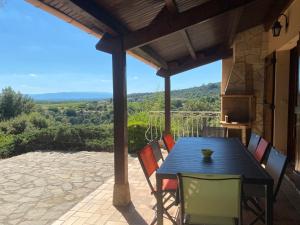a table and chairs on a patio with a view at GITE LAVANDE avec piscine privée CLASSÉ 4 Étoiles in Lagorce