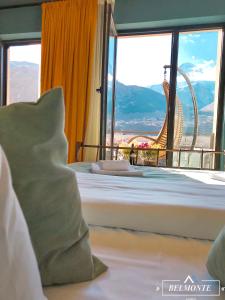 a hotel room with a bed with a view of the wheel at Belmonte Kazbegi in Kazbegi