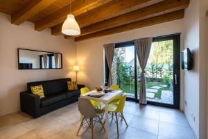 a living room with a table and a couch at Casa Tina Holiday Home in Diano dʼAlba