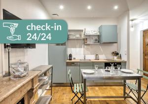 a kitchen with a table in a kitchen with the words check in at Cosy Appartement Lyon Valmy - parking in Lyon