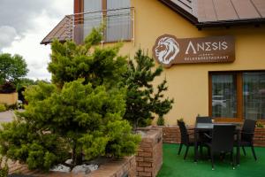 a restaurant with a table and chairs outside of it at Penzion Anesis - Apartmány in Turčianske Teplice