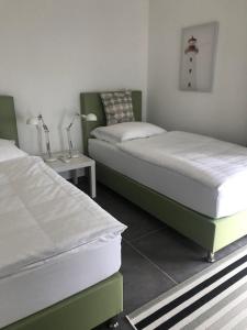 Кровать или кровати в номере Ferienhaus SEE & Ferienhaus SEEBLICK