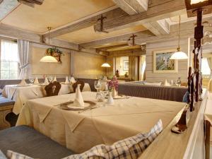 a dining room with a table and chairs in a restaurant at Landhotel Pfrondorfer Mühle in Nagold