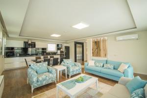 a living room with a blue couch and chairs at CRESCENT TWINS- BLUE VİLLA in Dalyan