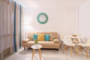 a living room with a couch and a table at Apartamento Marina Suite in Benalmádena