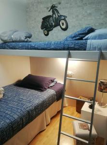 sypialnia z 2 łóżkami piętrowymi i skuterem na górze w obiekcie La casa del gatico w mieście Lumbier
