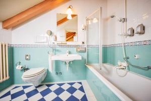 a bathroom with a toilet, sink, tub and shower at Grand Hotel Imperial in Levico Terme