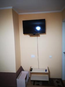 a room with a flat screen tv on the wall at Sadyba Anzhelika in Truskavets