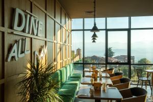 a restaurant with tables and chairs and large windows at Holiday Inn Telavi by IHG in Telavi +104 photos