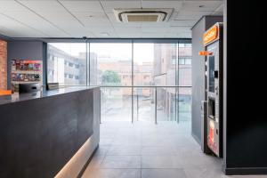 a bar in a building with a view of a street at easyHotel Glasgow City in Glasgow