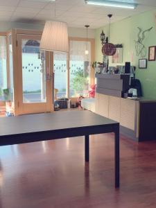 a living room with a table in the middle of a room at Backstreet Inn in Xiluo