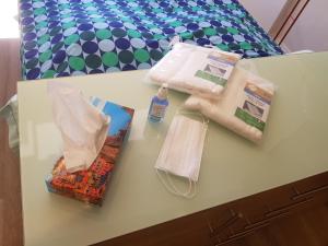 a table with bags and other items on a bed at PALAIS LUMIERE : la ''Chambre Blanche'' in La Ciotat