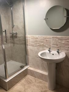 a bathroom with a sink and a shower and a mirror at Al Forno Restaurant & Inn in Norwich