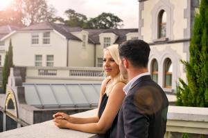 a man and a woman sitting on a bench at Muckross Park Hotel & Spa in Killarney
