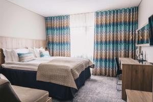 Säng eller sängar i ett rum på Best Western Plus John Bauer Hotel