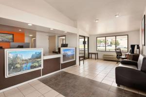 a living room with a large flat screen tv at Howard Johnson by Wyndham Harrisonburg in Harrisonburg