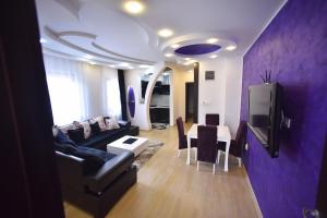 a living room with a couch and a table at Apartman Grk 5 in Zlatibor