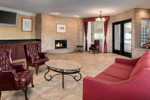 a living room with a couch and a fireplace at Days Inn by Wyndham Whitmore Lake in Whitmore Lake