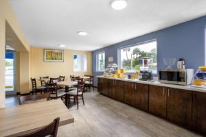 a restaurant with a counter and some tables and chairs at Days Inn by Wyndham Apopka/Orlando in Orlando