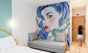 a mural of a woman on a wall in a bedroom at Motivo Thassos in Skala Potamias +43 photos