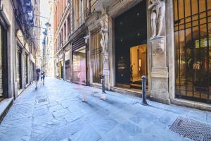 a city street with people walking down the street at Salvago 12 in Genoa
