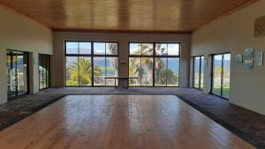 a large empty room with a table and windows at Barton Luxury Villas in Botrivier