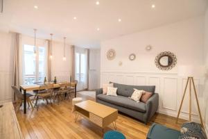 a living room with a couch and a table at Cosy and spacious apartment near Champs Elysée in Paris