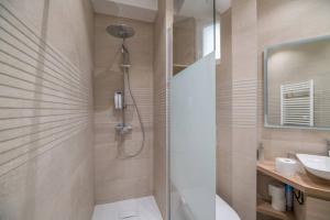 a bathroom with a shower and a toilet and a sink at Cosy and spacious apartment near Champs Elysée in Paris