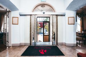 a entrance to a building with a sign on the door at Arensburg Boutique Hotel & Spa in Kuressaare