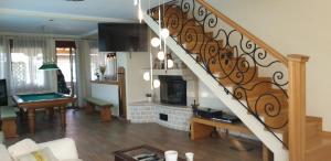 a staircase in a living room with a fireplace at Vila Orešac in Smederevo