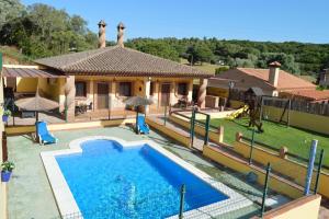 a villa with a swimming pool and a house at FANTASTICAS CASAS RURALeS in Barbate