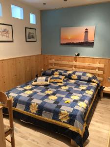 a bedroom with a bed with a lighthouse on the wall at B&B La Rosa dei Venti in Arco