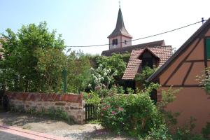 Westhoffenにあるle jardin du rempartの時計塔のある教会 +2枚の写真