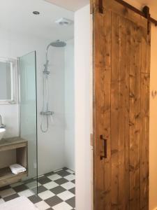 a bathroom with a sliding barn door and a shower at Romana in Zandvoort