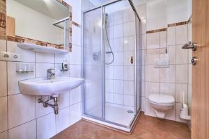 a bathroom with a shower and a sink and a toilet at Appartements Belledonne Ski & Bike in and out, zentrale Lage in Sölden +28 photos