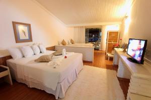 Un pat sau paturi într-o cameră la Porto Seguro Praia Resort - All Inclusive