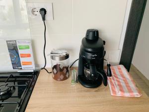 a coffee maker sitting on a counter next to a stove at Bridge tower Residence in Iaşi