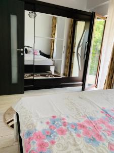 a bedroom with a bed and a large mirror at Bridge tower Residence in Iaşi