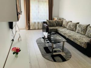 a living room with a couch and a coffee table at Bridge tower Residence in Iaşi
