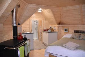 a bedroom with a bed in a wooden room at Cairngorm Bothies in Aboyne