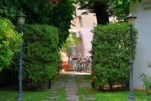 a garden with two street lights next to a building at B&b Mondello Resort in Palermo