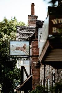 a sign on the side of a brick building at The Stag and Huntsman at Hambleden in Henley on Thames