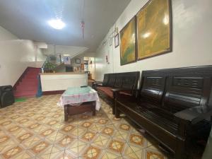 a waiting room with benches and a table in it at Wayu House in Shang-wu